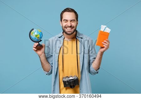 Joyful Traveler Tourist Man In Yellow Clothes With Photo Camera Isolated On Blue Background. Male Pa
