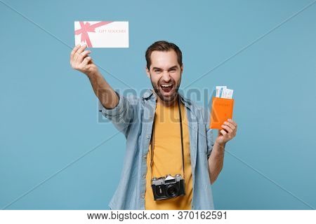 Happy Traveler Tourist Man In Yellow Clothes With Photo Camera Isolated On Blue Background. Passenge