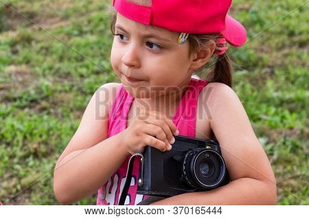Little Girl Shooting Blog On Retro Photo Camera сlose Up.