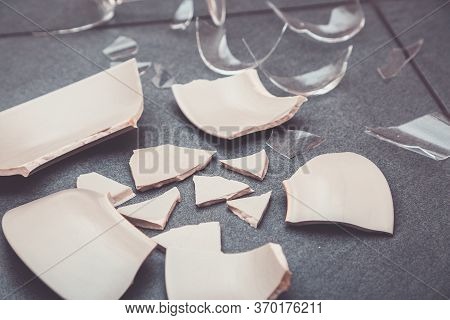 Broken Plate Or Broken Water Glass On The On The Floor In The Kitchen The Concept Of Accidents In Th
