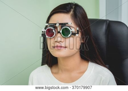 Consultation With An Ophthalmologist. Young Asian Woman In Clinic Office.