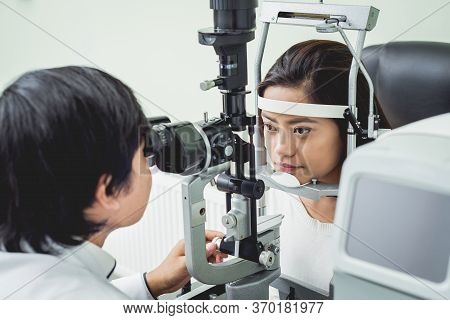 Consultation With An Ophthalmologist. Young Asian Woman And Doctor