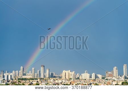 Aerial Cityscape Shot Of Buildings In Gurgaon Delhi Noida With A Rainbow Behind Them On A Monsoon Da
