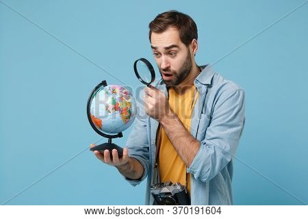 Perplexed Traveler Tourist Man In Summer Clothes With Photo Camera Isolated On Blue Background. Pass