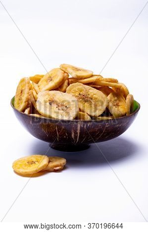 Healthy Snack, Crispy Dehydrated Unsugared Banana Chips In Bowl On White Background