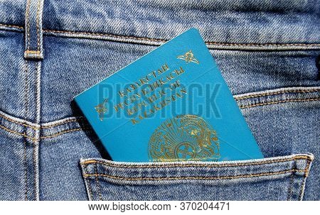Kazakhstan Passport Close Up In A Blue Jeans Back Pocket. Kz Passport Document.
