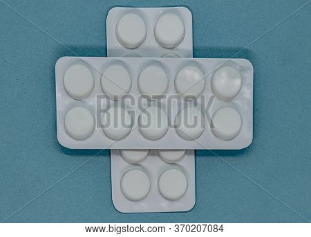 White Blisters With Pills Medical Drug On A Blue Background