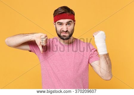 Confused Fitness Sporty Guy Sportsman In Headband In Home Gym Isolated On Yellow Background. Workout