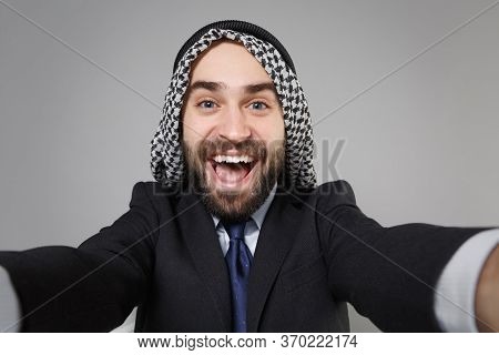 Close Up Of Cheerful Arabian Muslim Businessman In Keffiyeh Kafiya Ring Igal Agal Black Suit Isolate
