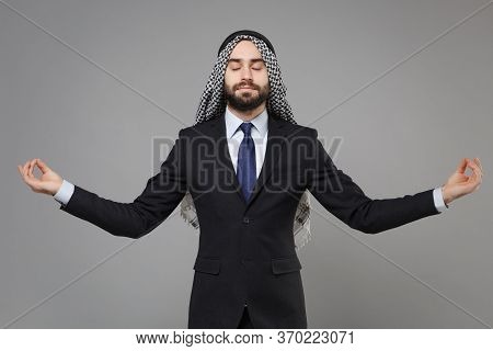 Arabian Muslim Businessman In Keffiyeh Kafiya Ring Igal Agal Classic Black Suit Isolated On Gray Bac