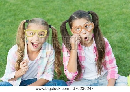 Looking Fancy. Party Girls Wear Prop Glasses On Green Grass. Playful Friends. Happy Childhood. Fashi