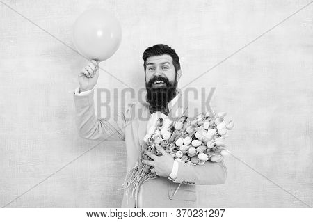 Art Of Charm. Happy Hipster Go Out On Date. Bearded Man Hold Tulips And Balloon. Perfect First Date 