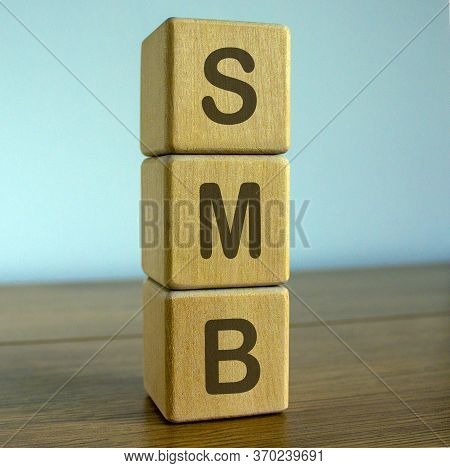 Concept Word Smb On Cubes On A Beautiful Wooden Table.