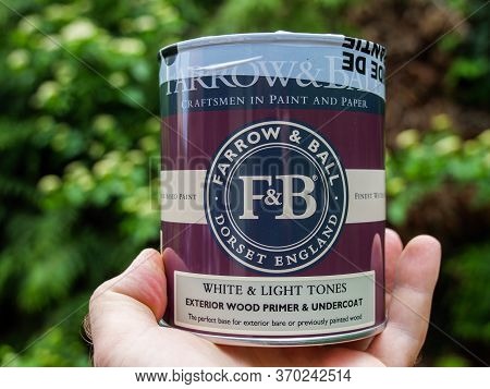 Paris, France - Mar 3, 2020: Man Hand Holding Against Green Background New Pot With Farrow And Ball 