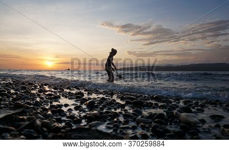 Banyuwangi, Indonesia - May 14, 2020 : A Woman Playing With The Dogs At Watudodol Beach Banyuwangi E