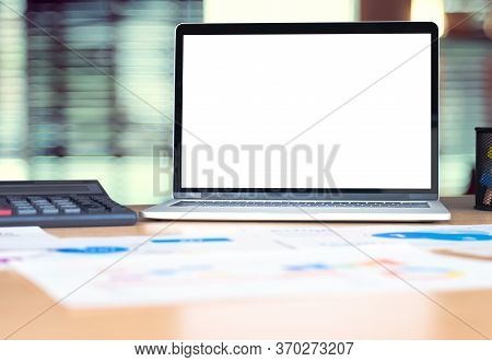 Mockup Laptop Computer Screen With Business Chart Market,caculator On Desk At Blur Modern Office .de