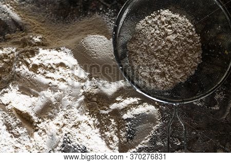 Colander With Flour On The Table. Stainless Steel Fine Mesh Strainer Colander Flour Sieve With Handl