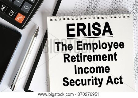 On The Table Lies A Smartphone, A Calculator And A Notebook With The Inscription - Erisa. The Employ