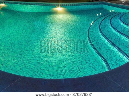 Pool At Night With Pure Blue Water Background. Top View Of Swimming Pool And Floor Texture Panorama 
