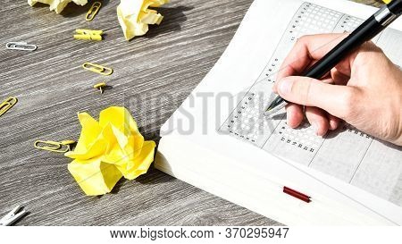 Student Hand With Pencil For The Exam. Printed School Test, Home Education, Study At Home