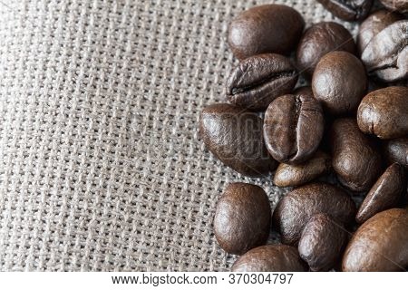 Close-up Of Coffee Beans On Linen Fabric With Copy Space