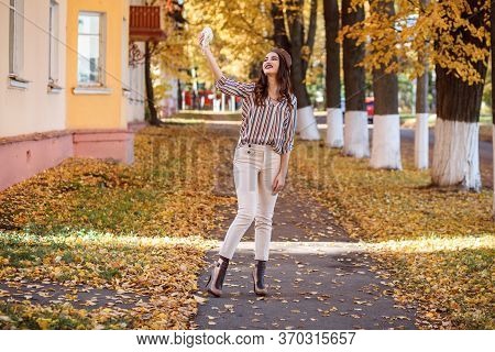 Cheerful Woman Is Taking Selfie With Her Instax Camera Outdoors In Autumn.