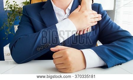 Closeup Image Of Official Accepting Bribe And Putting It In His Pocket. Concept Of Corruption In Pol