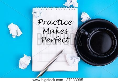 Practice Makes Perfect Notepad Writing Concept On A Blue Background With Pen And A Cup Off Coffee.