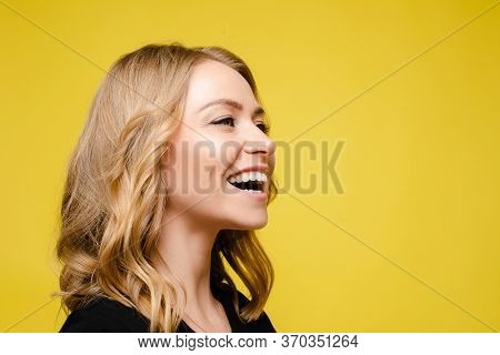 Porttrait Of Cheerful Young Female Looks Aside And Rejoices