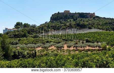 Montesa Castle Located On Hillside Against Blue Sky View, Church And Museum Inside, Agricultural Fie