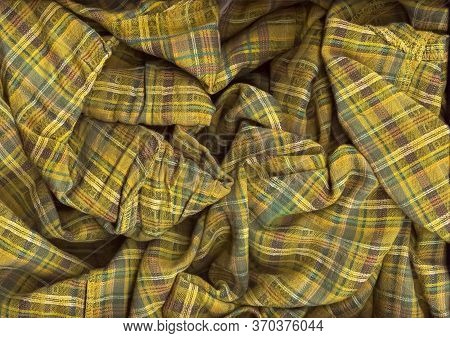 Chaotic Folded Green Checkered Fabric Background. A Detailed Shot Of The Texture Of Natural Fabric I