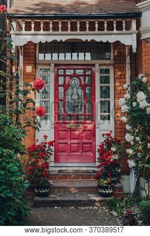 London, Uk - May 30, 2020: Dark Pink Stained Glass Front Door Of A Traditional Edwardian House In Lo