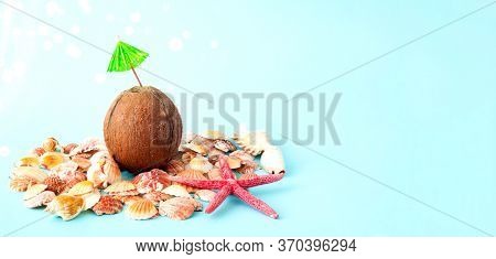Quarantini Or Homemade Drink With Coconut Milk The Background Of Seashells. The Concept Of New Popul