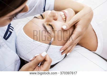 Lipolytic Injections In The Face. Photo Of Facial Contouring With A Cosmetologist. Injection Cosmeto