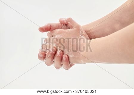 Coronavirus Or Covid-19 Concept. A Small Girl Washing Hands With Soap. Process Of Hand Washing With