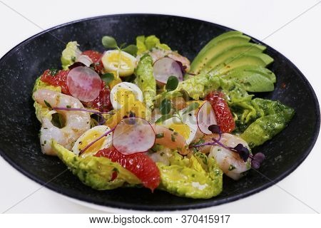 Salad With Avocado And Shrimps In Bowl, Top View, Copy Space, Black Background