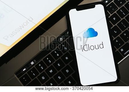 Hand Holding The Iphone With Apple Icloud Logo On The Screen. High Quality Photo