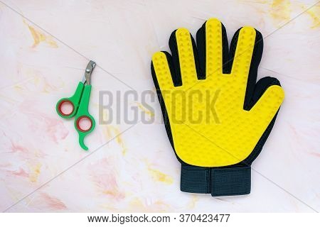 Yellow Silicone Glove And Nail Clippers For Cats And Dogs Grooming On Pink Background, Copy Space. P