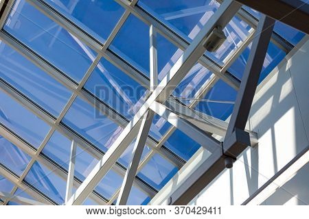 Steel Frame Of The Glazed Roof Of A Warehouse, Shopping Or Office Center. The Ceilings Are Made Of M