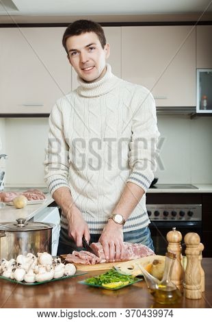 Closeup Of Cooking Veal Prince Orloff. Man Hands Cutting Meat