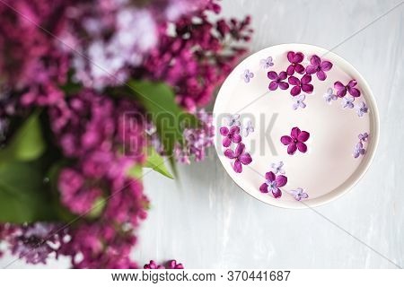 Five-pointed Lilac Flower Among Lilac Flowers In A Cup With Water. Spa Ritual. Lilac Branch With A F