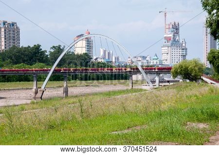 China, Heihe, July 2019: Bridge In The Park On The Embankment In Heihe City In Summer