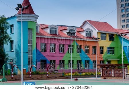 China, Heihe, July 2019: Kindergarten Building Near The Waterfront In Heihe City In Summer