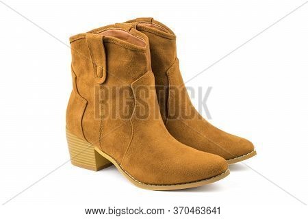 A Pair Of Fashionable Brown Suede Boots Isolated On A White Background. Fashionable Suede Womens Sho