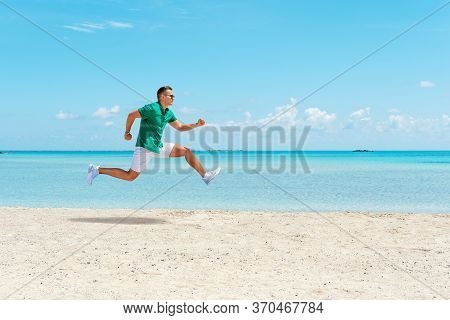 Happy Young Man Hurtling On The Beach. Summer Vacation Concept.