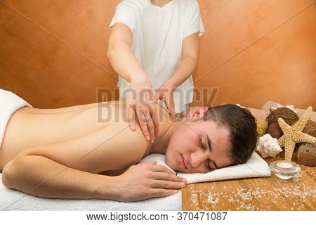 Young Man Getting Massage With Masseur