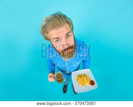 Man Drinking Beer And Eating Potato Fries. Man With Potato Fries. Beer. Fast Food. French Fries Pota