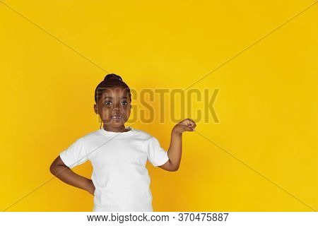Greeting Somebody, Showing Brofist. Little African-american Girls Portrait On Yellow Studio Backgrou