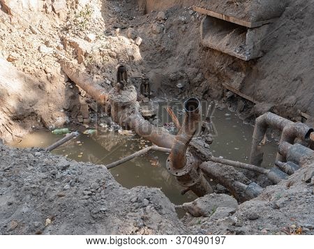 Broken City Sewage Conduit System After Erthquake. Deep Hole In The Ground With Cracked Pipeline And