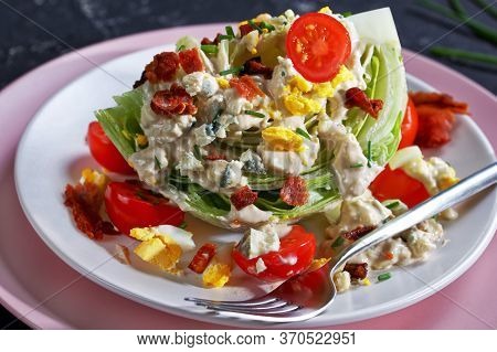 Close-up Of Iceberg Wedge Salad Topped With Blue Cheese Dressing, Crispy Fried Bacon, Cherry Tomatoe